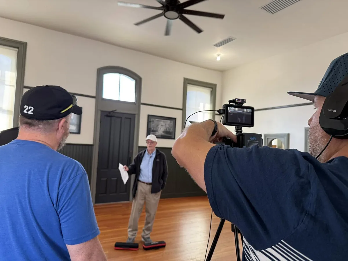 Behind the scenes on a City of Stuart promotional video shoot: camera operator and crew filming an on-location interview