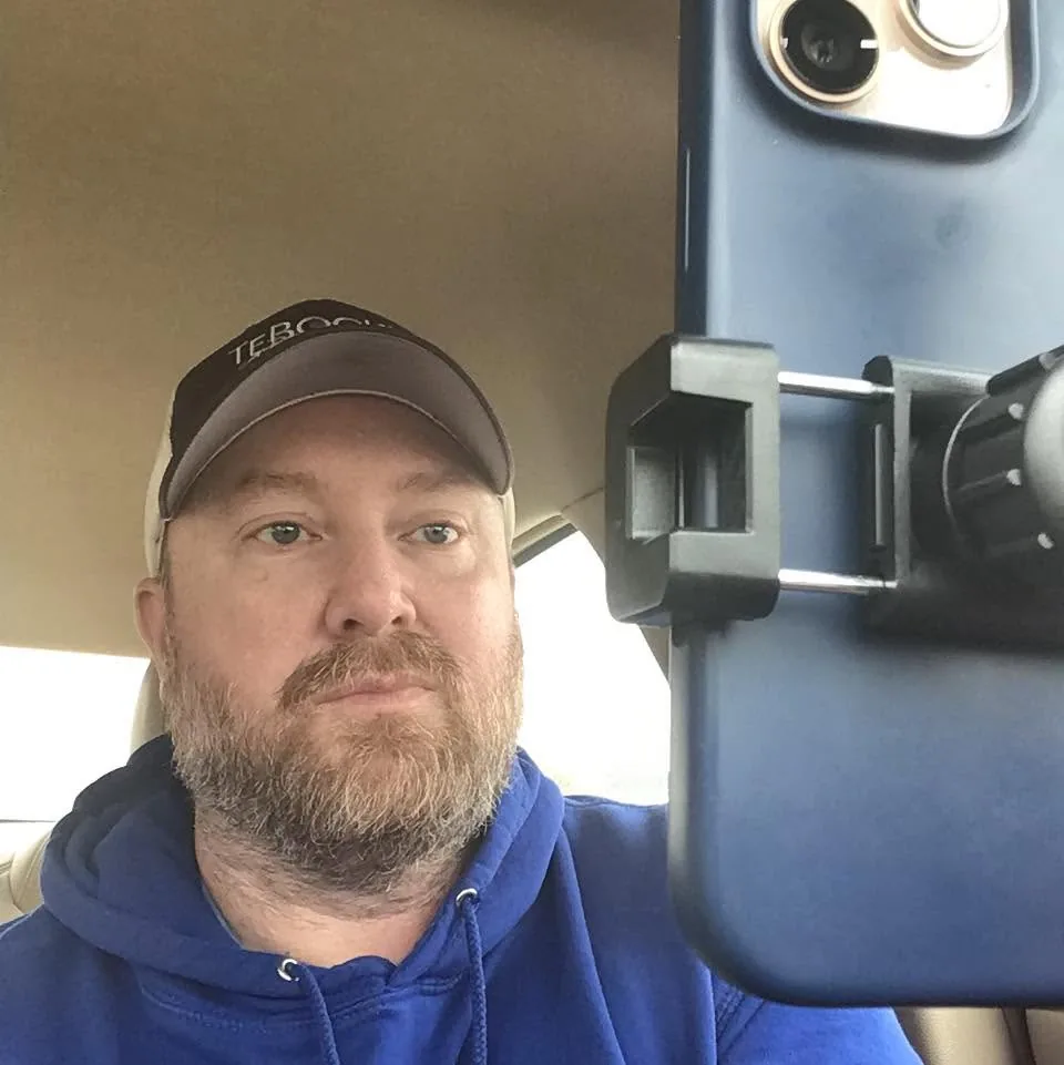 Nate Westre filming his own weekly reels with a phone rig mounted in his vehicle