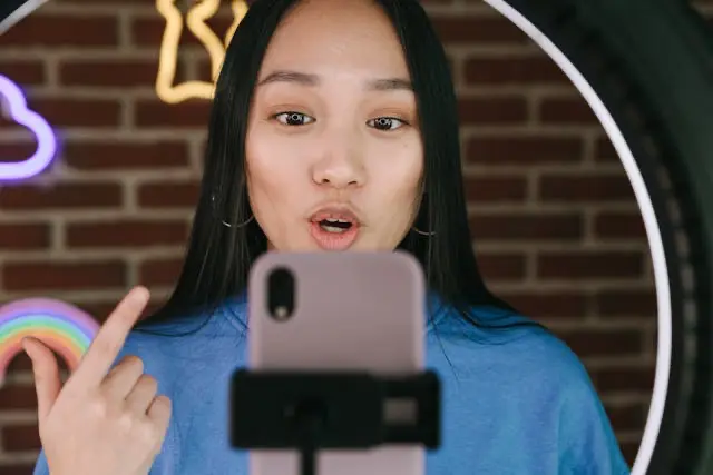 Influencer recording a video on her phone